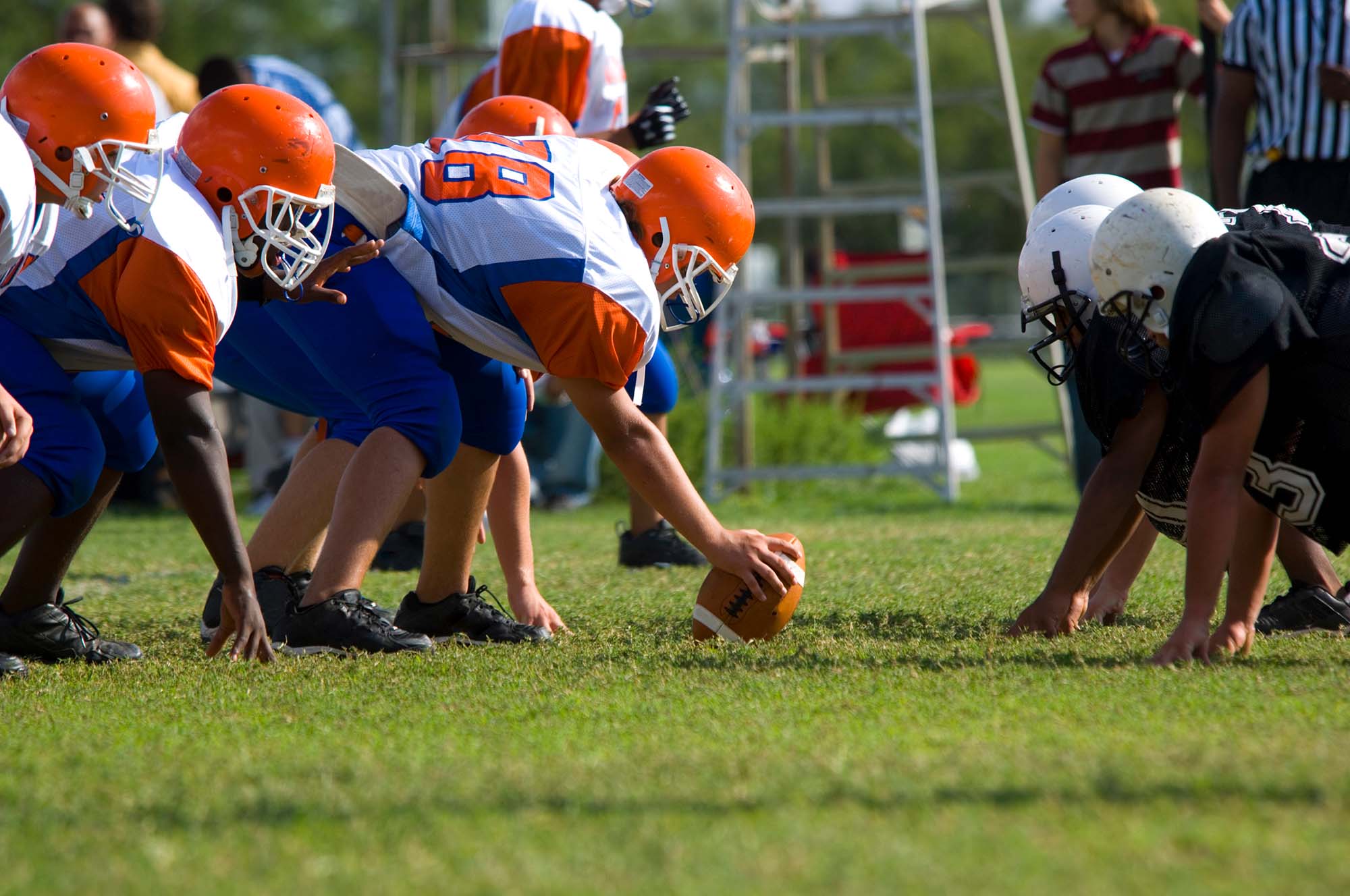 Youth football team with center ready to hike the ball